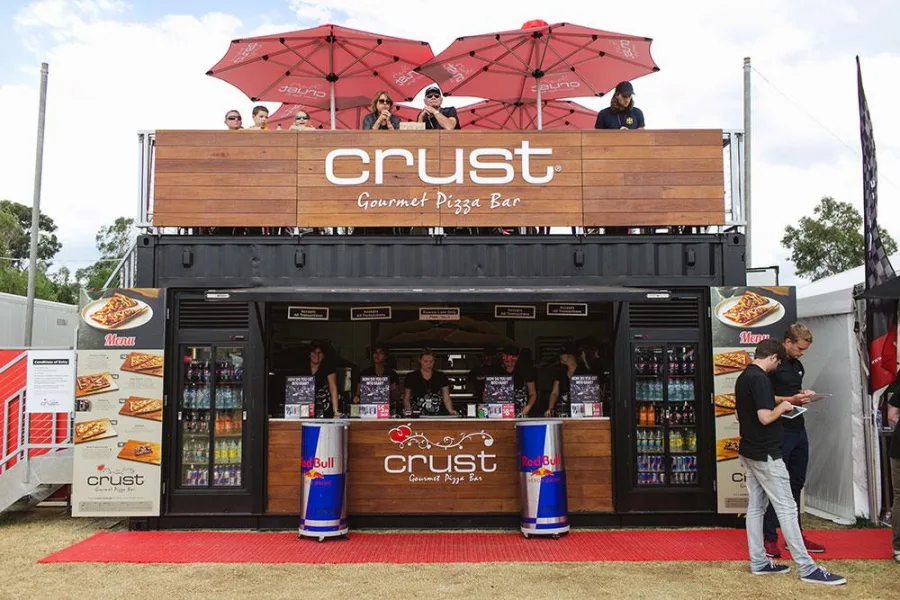 Compact container food outlet with a service window and branded signage